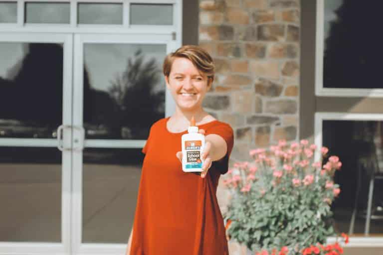 woman holding a glue in hand